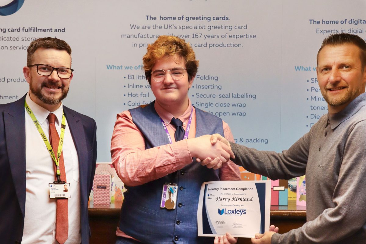 UTC Student Harry pictured receiving a certificate of completion for his work experience placement at Loxleys.