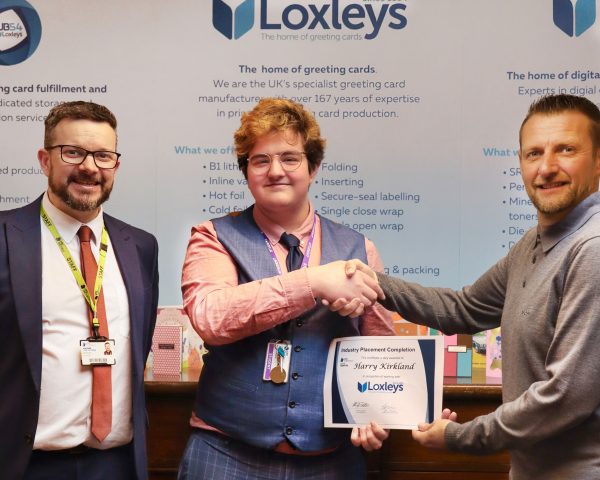 UTC Student Harry pictured receiving a certificate of completion for his work experience placement at Loxleys.